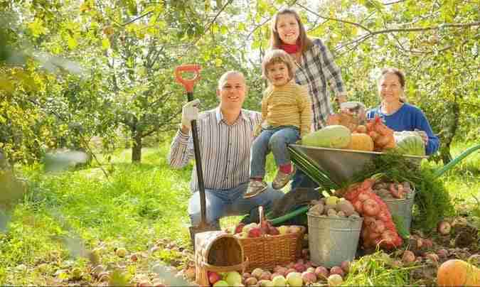 happy-family-with-harvest-in-garden-freepik-1-e1672760184722